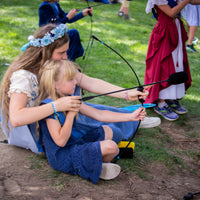 2025 Blue Princess helping her handmaiden learn to aim a bow and arrow