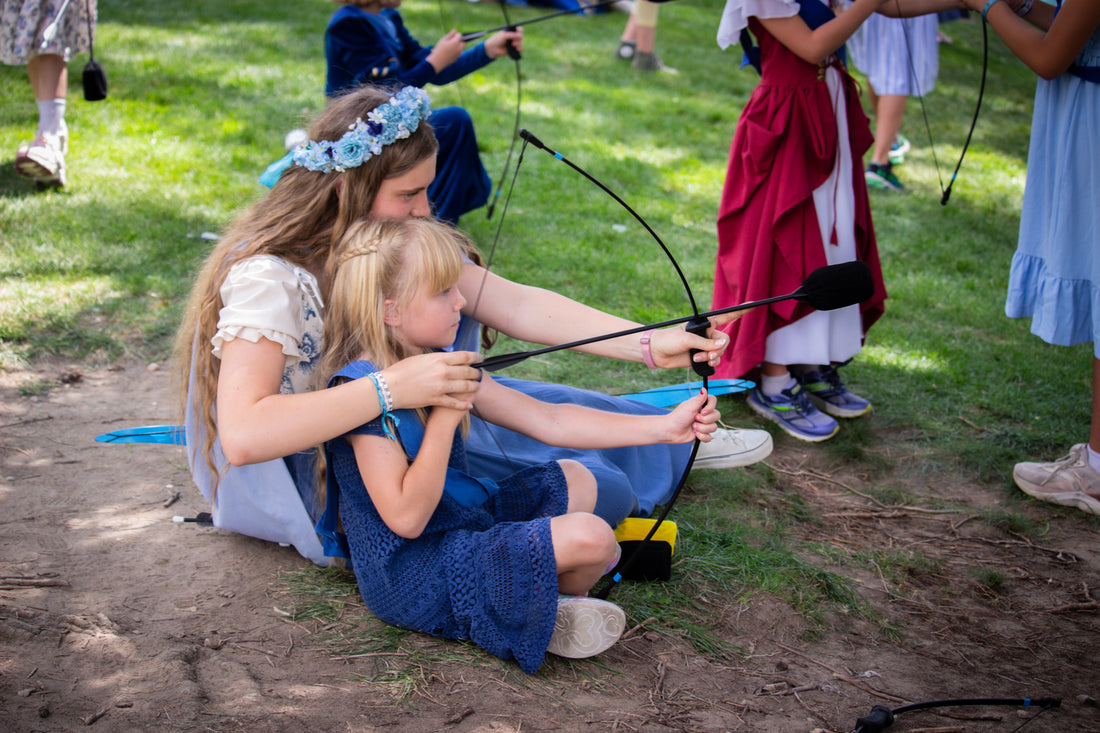2025 Blue Princess helping her handmaiden learn to aim a bow and arrow